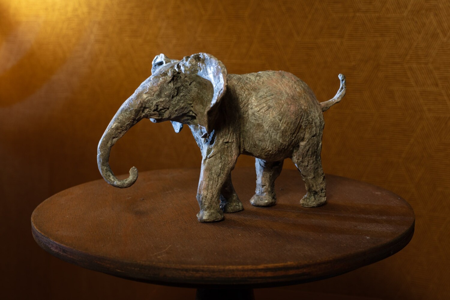 Bronze sculpture of an elephant titled "He's Not Heavy" by Heather Jansch